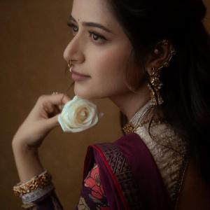 Graceful Smile of Actress Ashika Rangnath in Floral Elegance