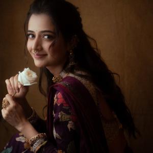 Graceful Smile of Actress Ashika Rangnath in Floral Elegance