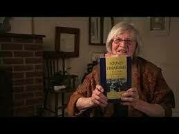 <p>Frieda Johles Forman holding <em>Found Treasures.</em> Still from her <a href="https://www.yiddishbookcenter.org/collections/oral-histories/interviews/woh-fi-0000807/frieda-johles-forman-2016">interview with the Wexler Oral History Project of the Yiddish Book Center</a>.</p>