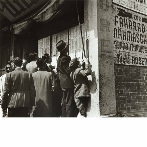 Hongkew refugees searching lists of concentration camp survivors, April 1946