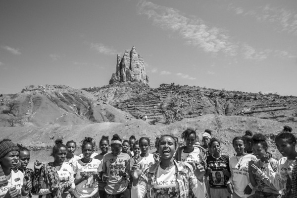 Marhawit (21, center) leads a group of female soldiers in a cheer. Many are minors who joined the Tigrayan army for safety. Leaders like Marhawit provide emotional support and a sense of unity and purpose. Neblet, Tigray, Ethiopia, 7 April 2024.