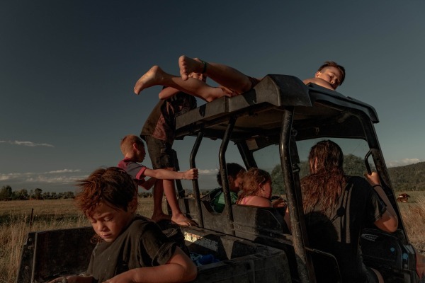 Children from the Teepa family drive the younger siblings home, after a swim in the river. Tūhoe children are taught independence and to care for other family members. Ruatoki, New Zealand, 27 January 2022
