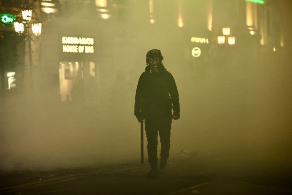 Rustaveli Avenue, which runs past the parliament of Georgia, lies covered by smoke, after police deployed tear gas against protesters. Demonstrators tried to take shelter in nearby alleys. Tbilisi, Georgia, 7 December 2024