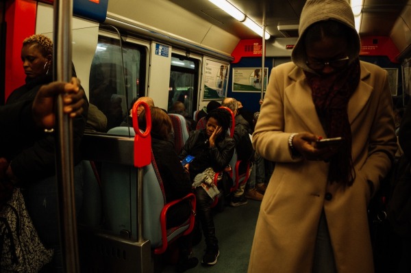 Ana Maria commutes to work at dawn. After freeing herself, aged 21, from employment by an abusive family, she eventually bought a house on the outskirts of Lisbon. Rio de Mouro, Portugal, 9 January 2024