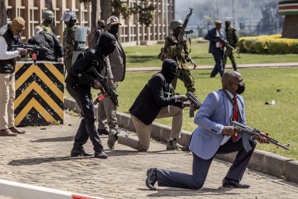 Kenyan police officers and security personnel protect the Kenyan Parliament against protestors attempting to storm the building. Reports that police fired live ammunition at demonstrators led to condemnation by human rights groups and other countries calling for investigations and police reform. Nairobi, Kenya, 25 June 2024