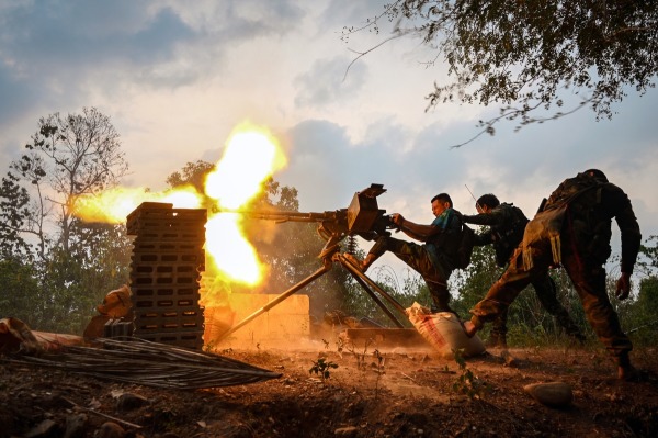 Karen National Liberation Army (KNLA) and SOF fighters fire a heavy machine gun, in an attack on a government military camp. Taung Soon, Kayin State, Myanmar, 21 April 2024