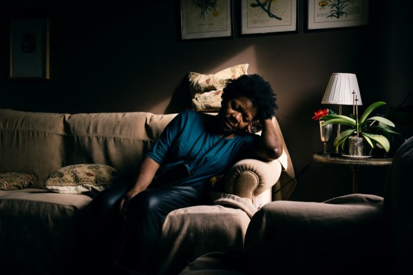 Ana Maria sits exhausted after helping a client who has had a fall. Lisbon, Portugal, 11 December 2023