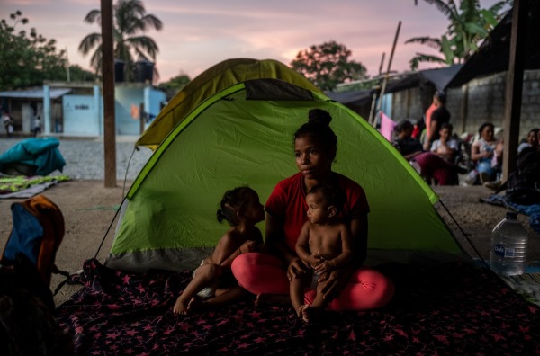 Yineska Andreina Colina (18) sits with her two daughters, Enyerlis Sofia Colina (2) and Eduanyerlis Saray Colina (9 months). By the time they got to Capurganá, Yineska had run out of money and had no idea how she would pay her way through the jungle. Capurganá, Colombia, 30 July 2023