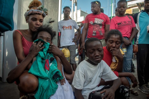 People grieving after learning that their family members were among a dozen people shot and killed by an armed gang. Pétion-Ville, Port-au-Prince, Haiti, 18 March 2024