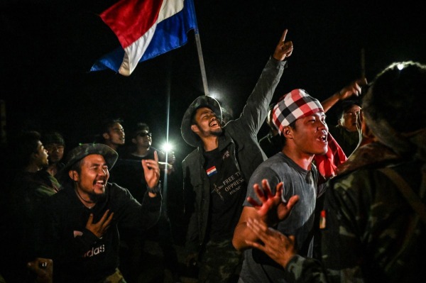 Khu Reedu (27, center), the commander of the Karenni Nationalities Defense Force, and fellow fighters celebrate victory over a government military base. Shadaw, Kayah (Karenni) State, 14 February 2024