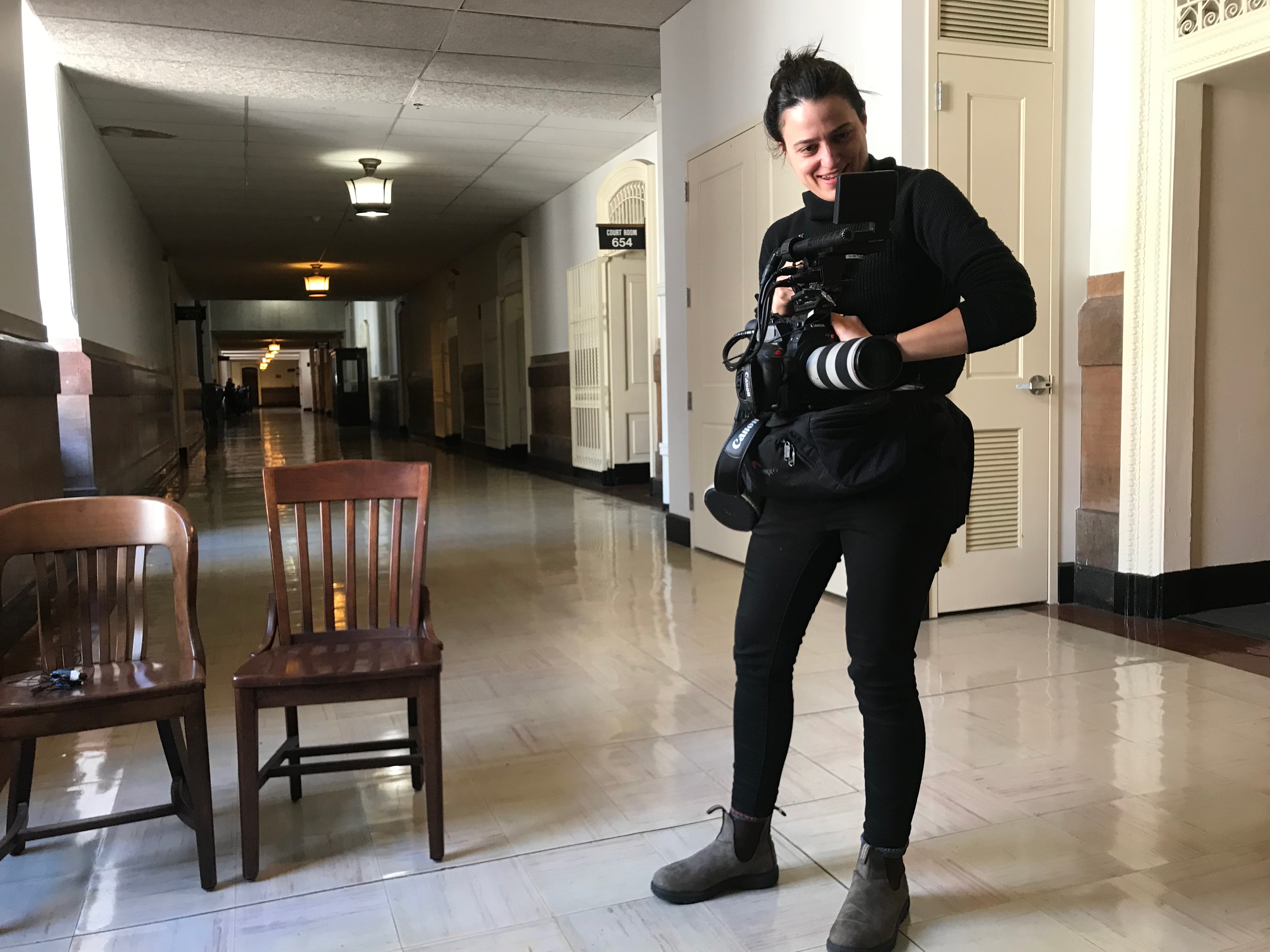 Nicole Salazar with camera in halls of D.A. office