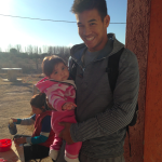 Missionary, Paul Balleza, holding baby "Millie," one of the several children who live in the home for mothers and their young children 