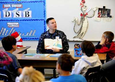 Medium mineman seaman justin foos reads to children at mcgaugh elementary school as 56a0c0 1024