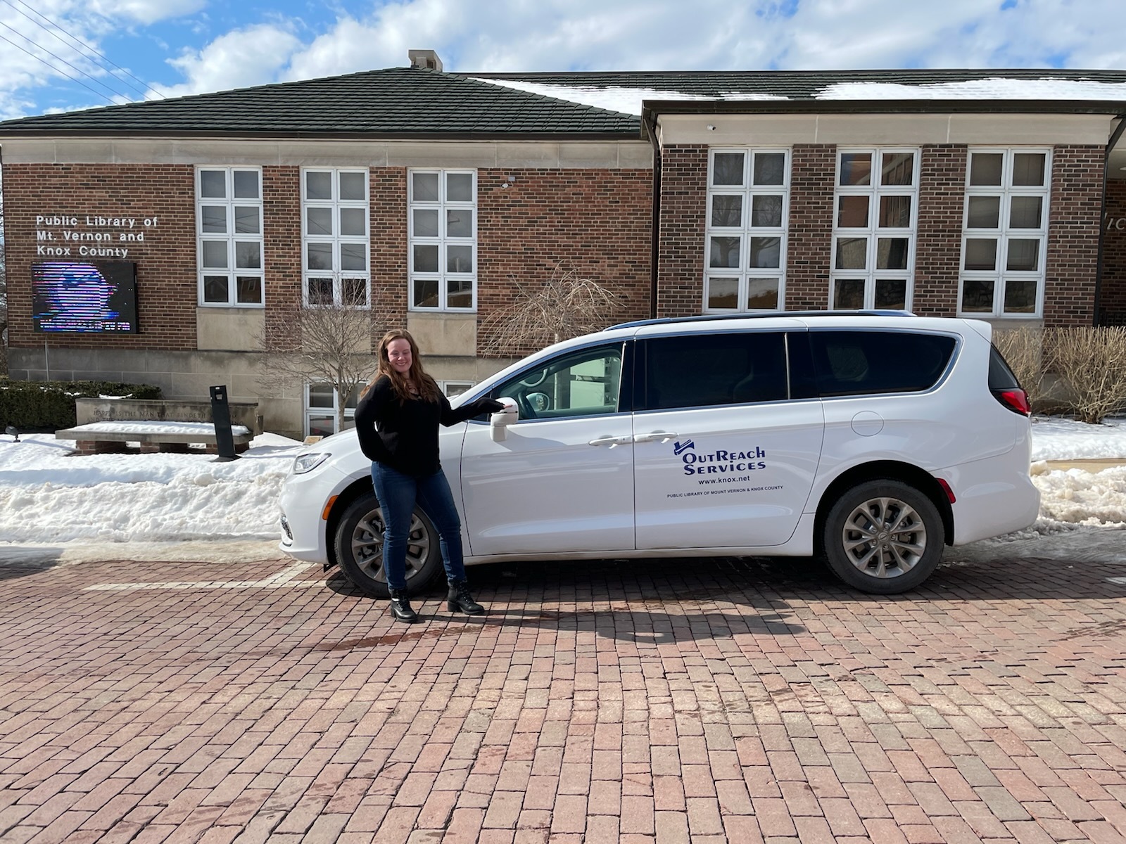Van in front of library