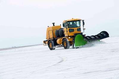 Medium a snow plow removes snow from the flightline on minot ff550f 1024