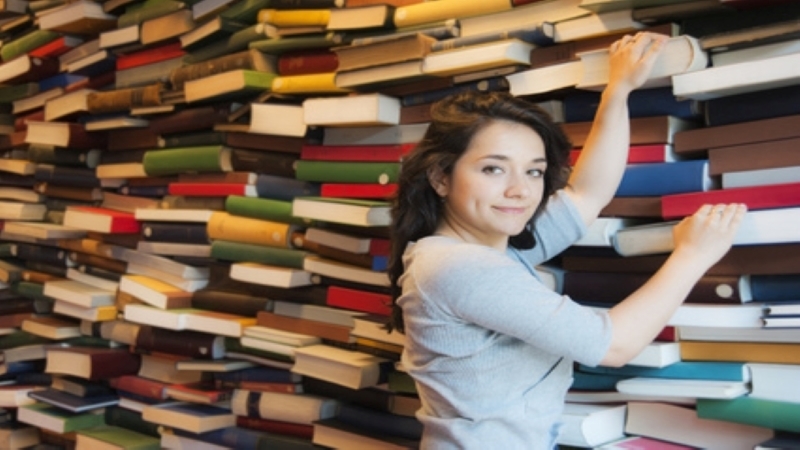 Stock girl grabbing book at lib