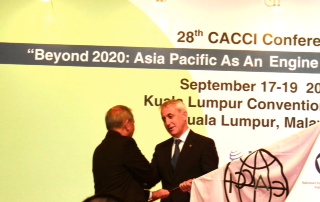 Asian-Pacific business leaders shake hands at the 28th CACCI Conference in Kuala Lumpur. 