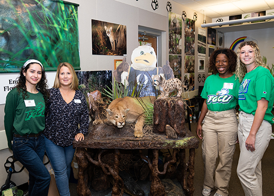 Photo shows FGCU Students and faculty in Panther Posse room