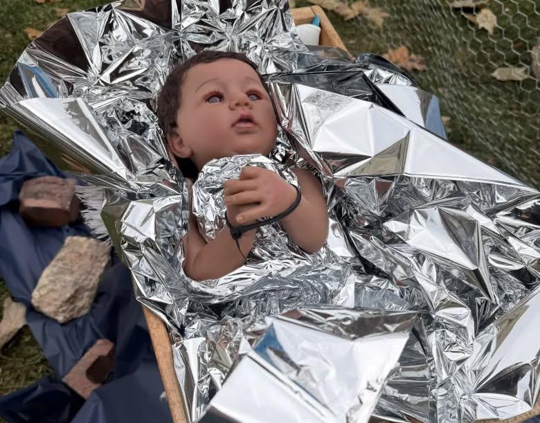 Anti-ICE Nativity at Evanston’s Lake Street Church shows Mary and Joseph in gas masks, baby Jesus with zip-tied hands; the display has faced repeated vandalism and drawn sharp criticism.
