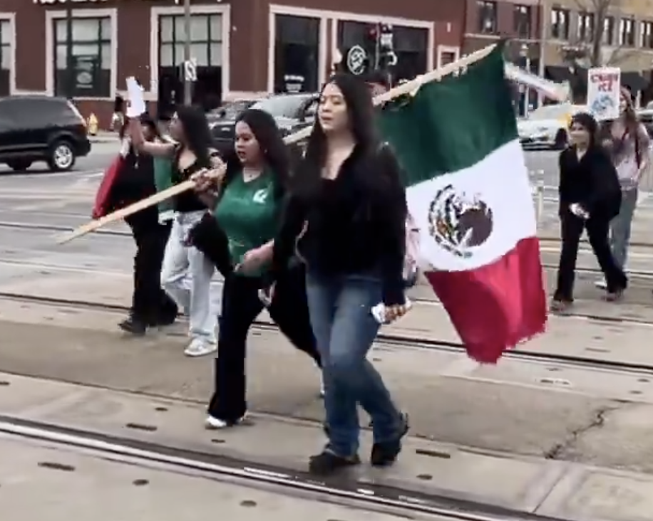 Students at Lyons Township High School in La Grange march through downtown on Feb. 17 during an anti-ICE protest, holding signs and chanting as part of a student walkout.