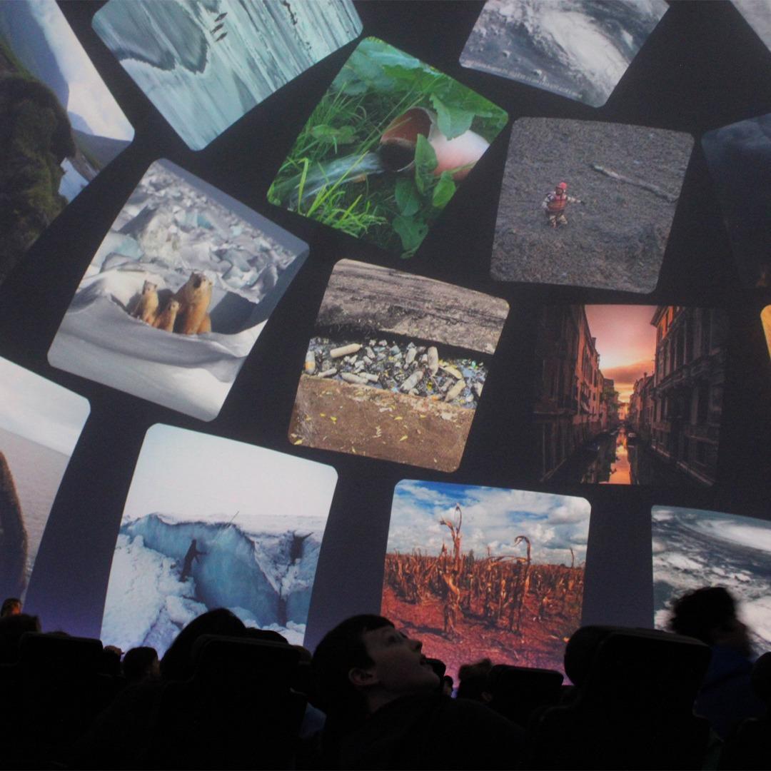 Students at Adler Planetarium’s “Climate Change and Me” exhibit view displays on rising emissions and temperatures.