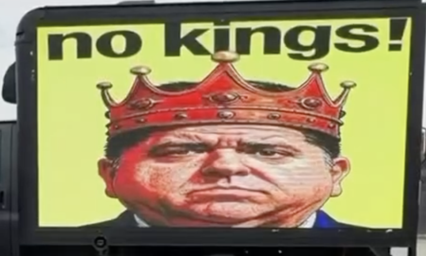 DuPage GOP Chair Coyne stands in front of an LED truck displaying “Vote Out King Pritzker!” that will be deployed to Saturday’s “No Kings” protests in DuPage County.