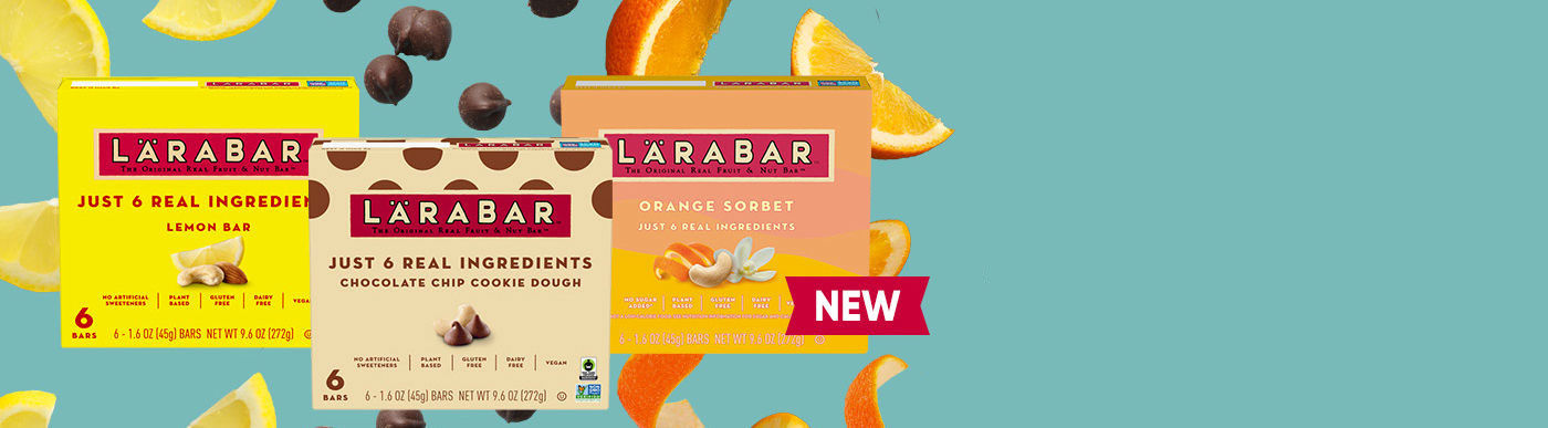 Lemon bar, chocolate chip cookie dough and orange sorbet larabar boxes in foreground. Falling fruit and chocolate in background
