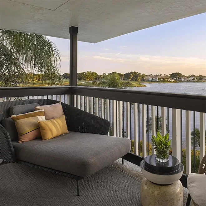 Lounge chair on a deck overlooking a lake