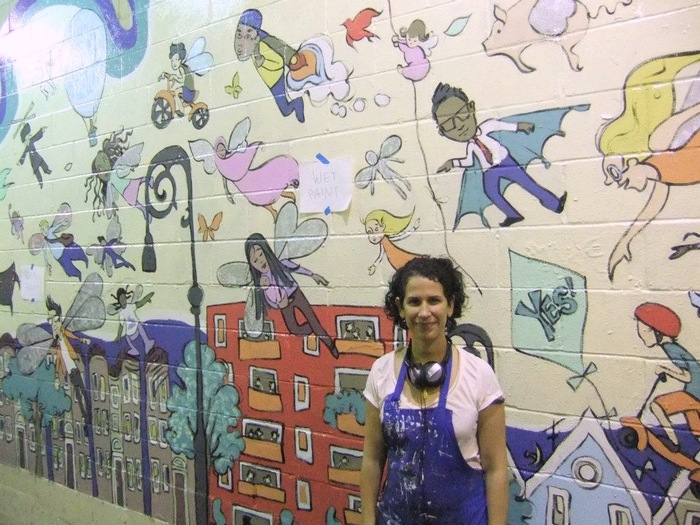 Susan Jaramillo and her mural from Phase 1 of the project