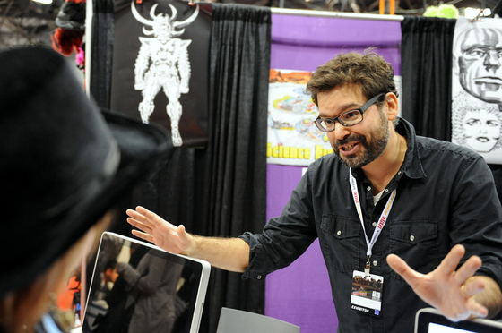 Director Judd Ehrlich talking to a Jack Kirby fan at NY Comic Con. Photo by Kendall Whitehouse.