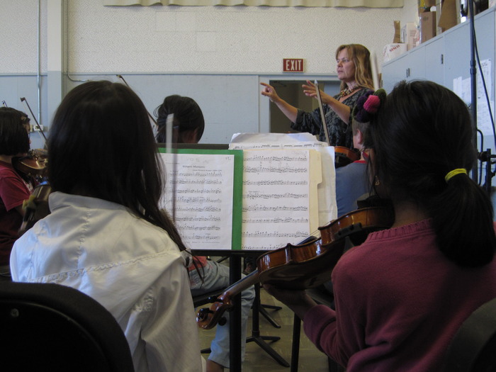 PACO's Director of Preparatory Orchestra & Superstrings Kris Yenney. Kris played in PACO as a child herself and now she conducts PACO!