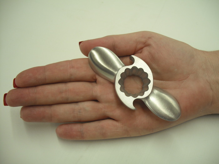 a hand holding a metal tool
