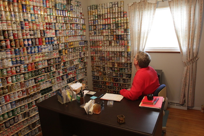 Lance gazing at s small part of his massive beer can collection.