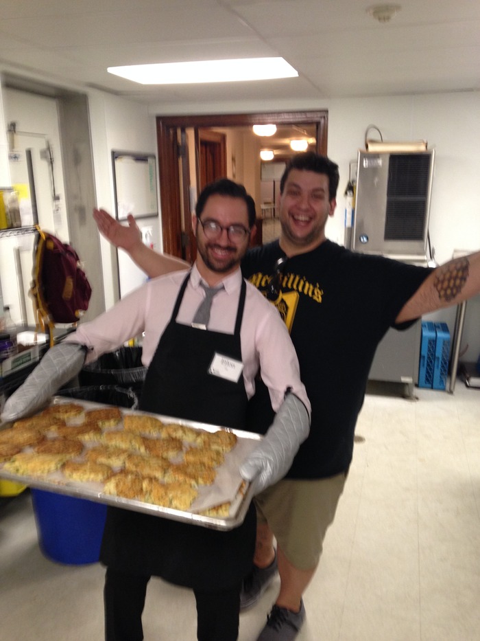 Zahav manager Eilon Gigi volunteering at BSM, with exec chef Steve Seibel and a lot of parmesan-crusted pork loin for their guests.