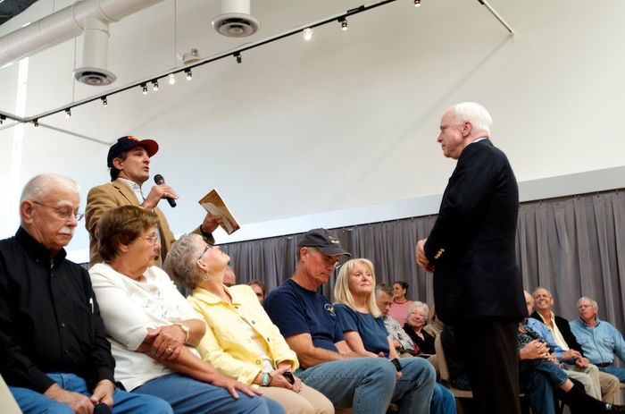 Jeff Zeidman, a resident of Green Valley, holds up a copy of the Constitution to highlight his point about the failure of the federal government during a town hall with U.S. Sen. John McCain in 2013. Photo by Paul Ingram/TucsonSentinel.com