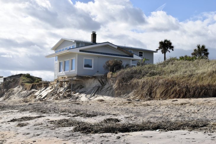 house on slope with erosion