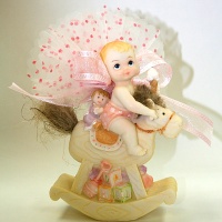 baby on rocking  horse figurine