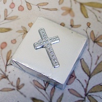 Silver wrapped chocolate with cross shape