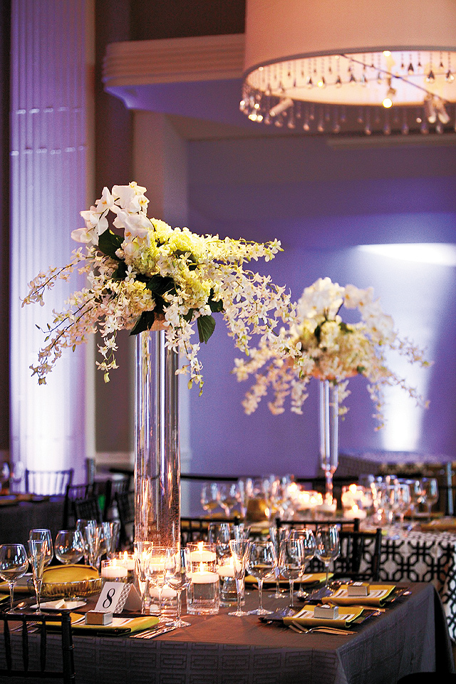 Pin spots on florals and custom uplighting on the walls by Level 11 drew attention to the centerpieces and enhanced the space.