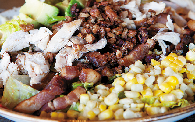A Southern twist on a Cobb salad which has corn, Honeycrisp apples, hand-cut Applewood-smoked bacon, poached chicken breast, and is topped with BBQ ranch dressing.