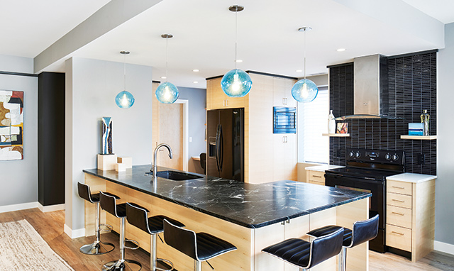 The dark backdrop adds flair in this kitchen that uses shades of gray to create elegance. Photo courtesy of Vujovich Design Build