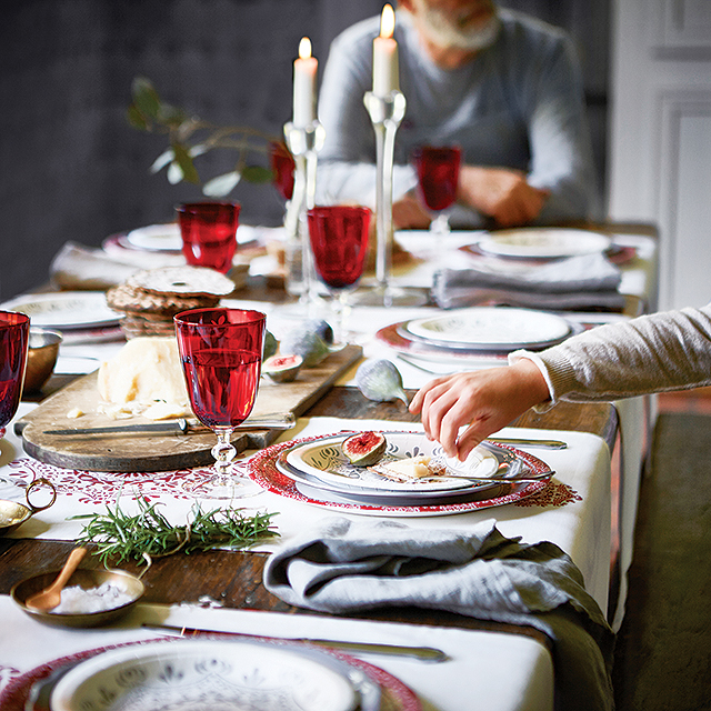 Paper plates never looked so good! Colorful wine glasses and Ikea's neutral Vinter 2015 table runners ($6.99 each) placed horizontally create a festive, yet elegant tablescape.