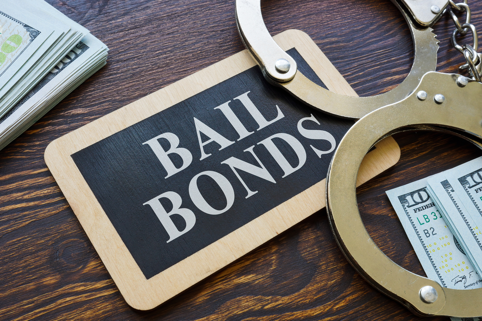 Bail bonds sign with handcuffs and cash, symbolizing financial aspects of DUI arrests and bail processes in Texas.