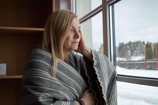 Woman looking out window