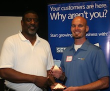 PSACO President Steve Glenn presents ServeNow's Trent Carlyle with an award representing the PSACO-ServeNow partnership.