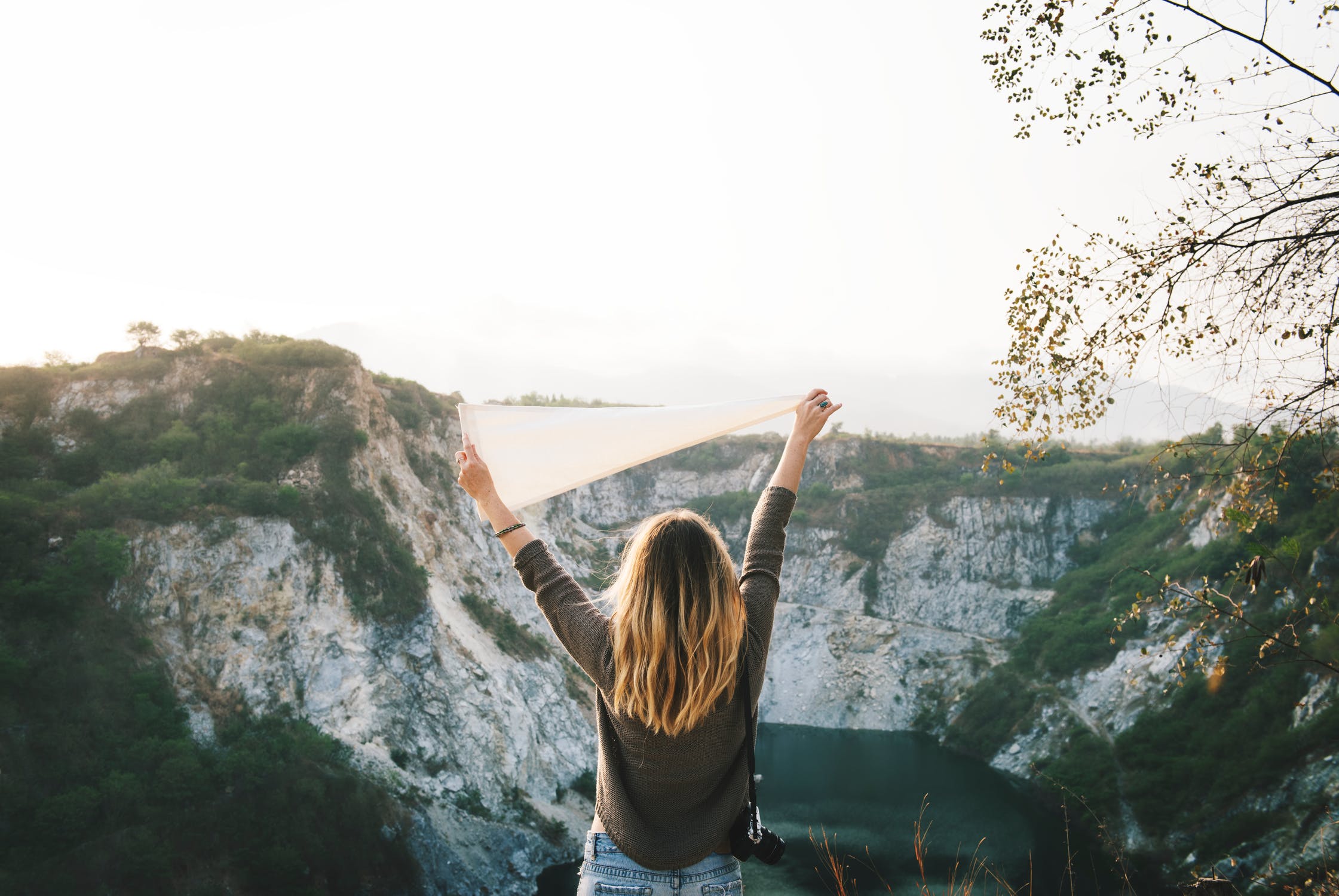 Picture of a woman travelling Into the World looking at a mountain