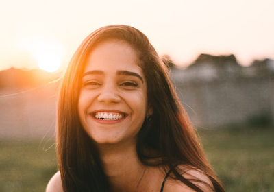 Smiling girl by sunset