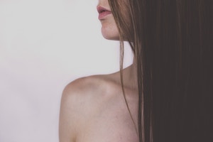 Shoulder and chin of a woman.