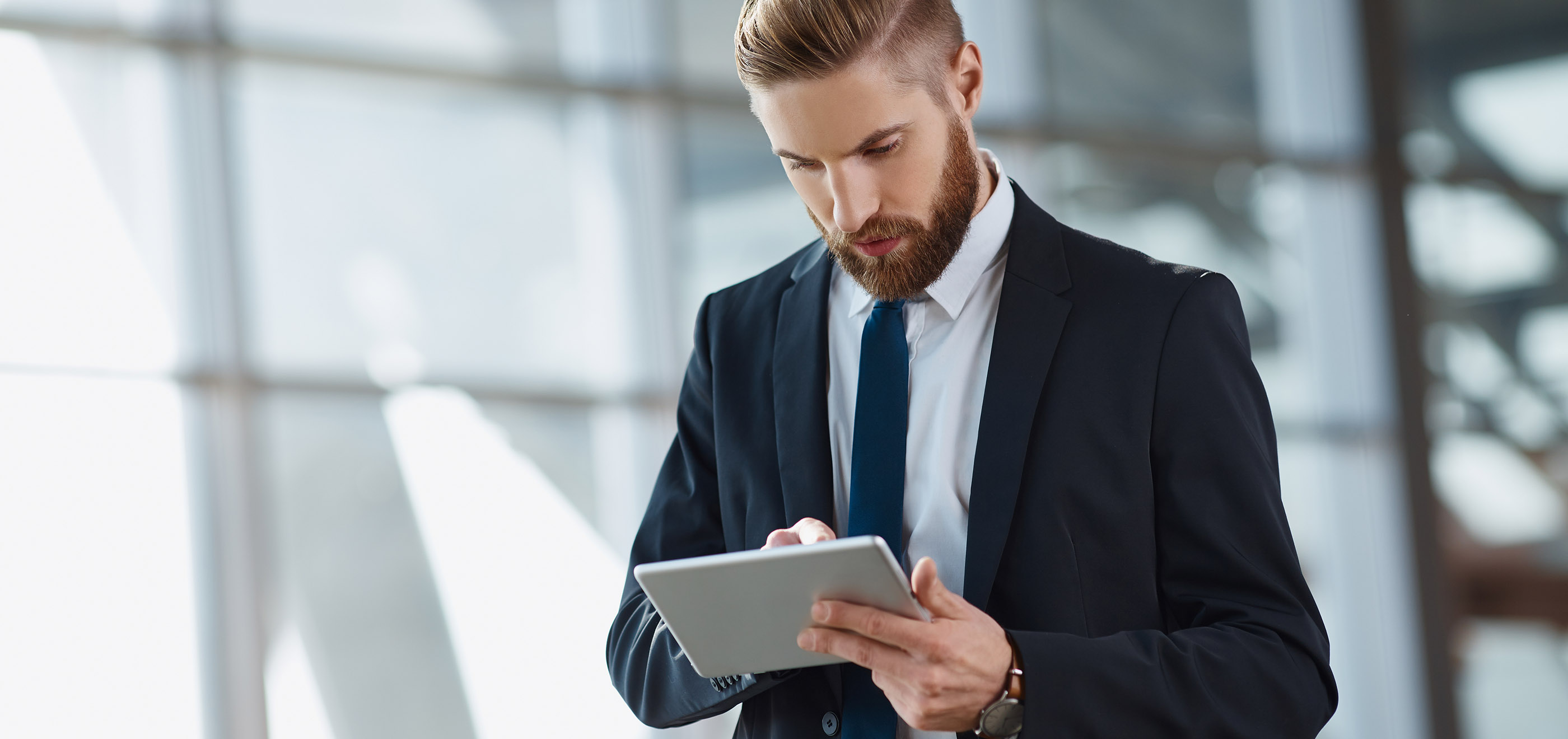 man with beard working on tablet