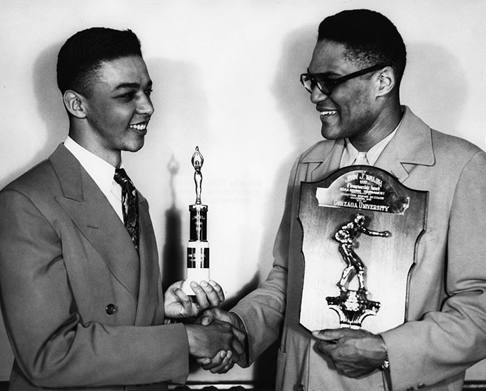 John Hopkins and Carl Maxey with debate and boxing trophies, 1950